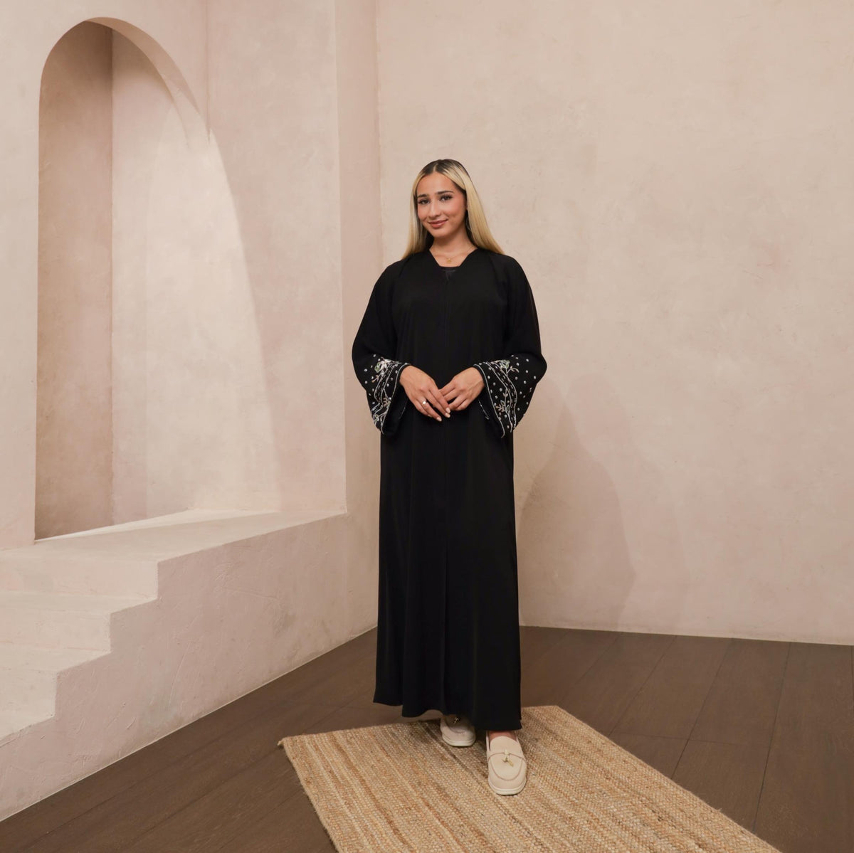 Reema Abaya available in Black, Vanilla, and Chocolate Brown with golden and silver beaded sleeves in a floral and leafy design. Made from crepe fabric with popper buttons, available in sizes 50-60. Includes a matching hijab.