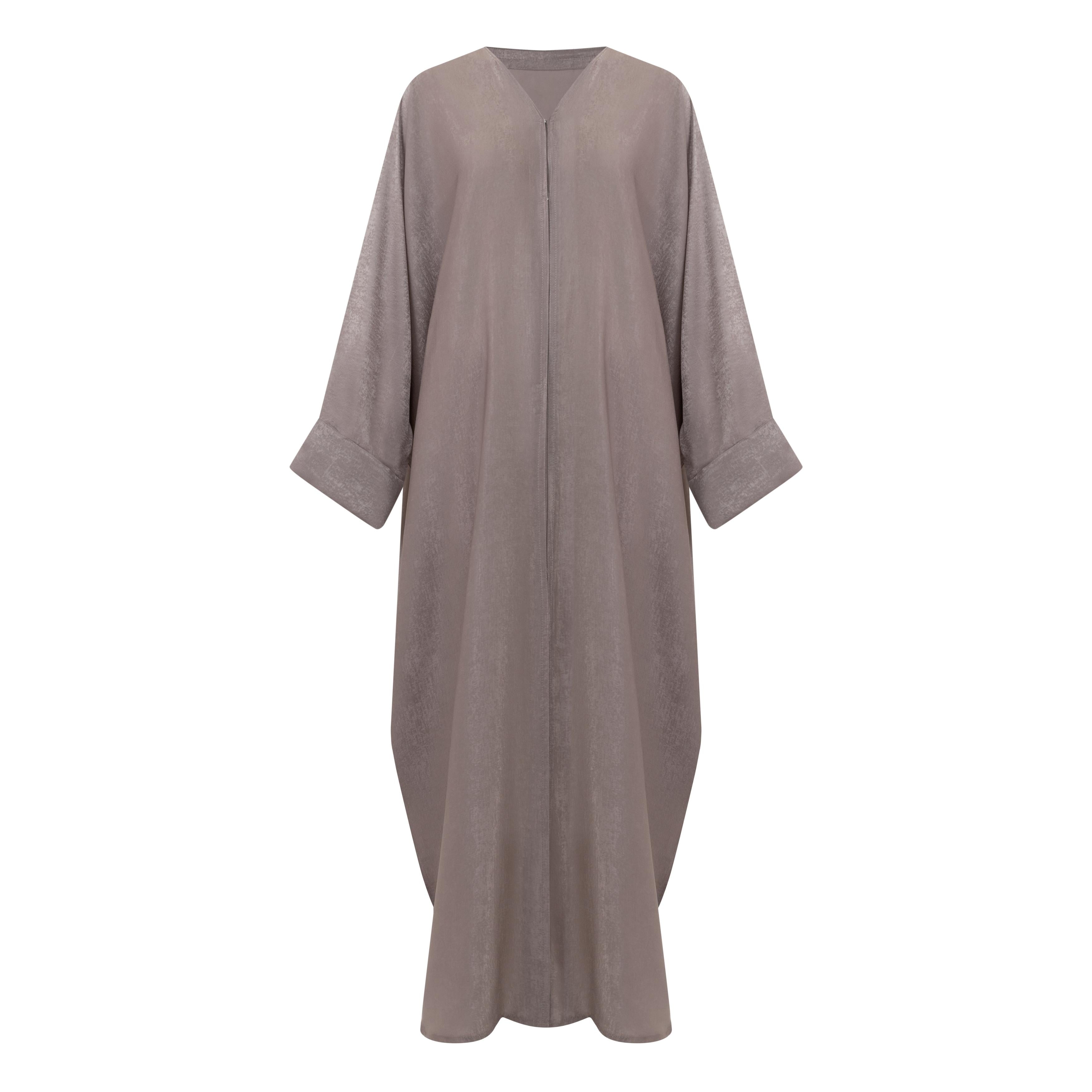 The Azeena Abaya, crafted from premium Farasha fabric, comes in five versatile shades and sizes 50-60, combining elegance with everyday comfort.